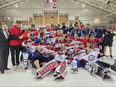 Members of the Lakeshore Canadiens gather around the Schmalz Cup after the team beat the Clarington Eagles 5-4 at the Garnet B. Rickard Recreation Complex on Friday to take the best-of-seven series 4-1 and capture the club's second Provincial Junior Hockey League title in three years.
